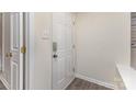 A clean, bright entrance with a security door, neutral walls and modern flooring at 1101 E Morehead St # 32, Charlotte, NC 28204