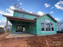 House under construction, showcasing a covered patio and large windows at 1017 Wandsworth Pl # Ken0108, Charlotte, NC 28215