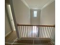 View of upstairs hallway with open railing overlooking the foyer at 1017 Wandsworth Pl # Ken0108, Charlotte, NC 28215