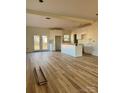 Spacious kitchen with white cabinets, an island, and light-colored wood flooring at 1176 Greenheather Dr, Salisbury, NC 28147