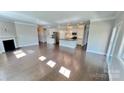 Spacious living room adjacent to the kitchen, featuring hardwood floors and fireplace at 126 E Northstone Rd, Mooresville, NC 28115