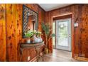 Warm entryway with wood paneling, a decorative mirror, and a view to the outside at 231 Cheek Rd, Clover, SC 29710