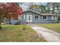 Charming home exterior featuring grey siding, a red roof, and a well-maintained yard at 231 Cheek Rd, Clover, SC 29710