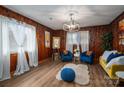 Inviting living room with hardwood floors, wood-paneled walls and natural light at 231 Cheek Rd, Clover, SC 29710