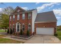 Charming brick home with a two-car garage, complemented by a manicured lawn and inviting entrance at 2512 Holly Oak Ln, Gastonia, NC 28056