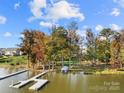 Picturesque waterfront view with private boat dock, lake access, and mature trees overlooking a calm, serene lake at 25566 Seagull Dr, Lancaster, SC 29720