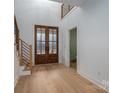 Inviting entryway with wood-framed glass doors and staircase with sleek, modern railings at 6630 Vesuvius Furnace Rd # 1, Denver, NC 28037