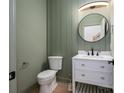 Stylish half-bathroom with modern fixtures, vanity with storage, and wainscoting at 6630 Vesuvius Furnace Rd # 1, Denver, NC 28037