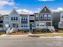 Modern townhouses with gray and white exteriors, featuring front porches and landscaping at 118 Berkeley Ave # D, Mooresville, NC 28117