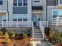 Townhouse entrance with steps, white railing, and small front patio at 118 Berkeley Ave # D, Mooresville, NC 28117