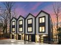 Three-unit modern townhome building with attached garages and contemporary design at 162 Mattoon St, Charlotte, NC 28216