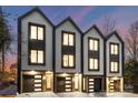 Three-unit modern townhome building with attached garages and contemporary design at 162 Mattoon St, Charlotte, NC 28216