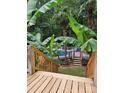 Beautiful backyard landscaping around the pool deck with tropical plants and a wooden staircase at 3107 Balkan Dr, York, SC 29745
