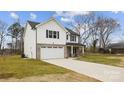 Stylish two-story home featuring a brick-accented garage, light siding, and welcoming covered front porch at 5319 Carden Dr, Charlotte, NC 28227