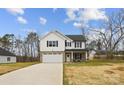 Inviting two-story home features a brick-accented facade, white siding, and a welcoming front porch at 5319 Carden Dr, Charlotte, NC 28227