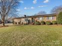 Brick ranch house with landscaped yard at 105 Victoria Dr, Statesville, NC 28625