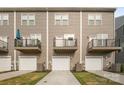 Townhome exterior with garage and balconies featuring neutral siding and manicured lawns with a well maintained driveway at 4018 Capital Ridge Ct, Charlotte, NC 28205
