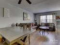 Spacious dining area with wood table and leather sofas at 4609 Coronado Dr # O, Charlotte, NC 28212