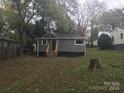 Backyard view of the home with new wooden stairs leading to the elevated entrance at 605 N Mcfarland N St, Gastonia, NC 28054