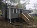 Backyard view of the home with new wooden stairs leading to the elevated entrance at 605 N Mcfarland N St, Gastonia, NC 28054