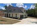 View of the home's side and back showcasing an attached garage and manicured landscaping at 217 Heartland Dr, Rock Hill, SC 29732