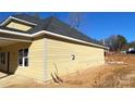 Side view of the house showcasing its light-yellow siding and a covered porch at 217 Heartland Dr, Rock Hill, SC 29732