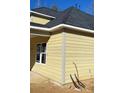 Another side view highlighting the house's light-yellow siding, windows and simple design at 217 Heartland Dr, Rock Hill, SC 29732