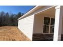 Side view of the home showing the siding and stone foundation on the property at 217 Heartland Dr, Rock Hill, SC 29732