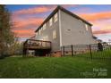 A home's backyard features a wooden deck and a black metal fence at 2624 Woodlands Creek Dr, Monroe, NC 28110