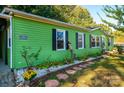 Green mobile home with stone accents and landscaping at 3401 Stony Brook Cir, Newton, NC 28658