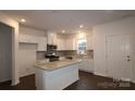 Modern kitchen with white cabinets, granite island, and stainless steel appliances at 3543 Nimbell Rd, Monroe, NC 28110