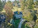 Stunning aerial view of a charming home with mature trees and a pristine golf course in the backdrop at 94 Heritage Dr, Lake Wylie, SC 29710