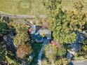 Overhead view of the charming house nestled among mature trees, with a golf course nearby at 94 Heritage Dr, Lake Wylie, SC 29710