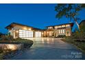 Modern home with a three-car garage, stone accents, and a well-manicured lawn in a cul-de-sac at 109 Twiggs Ln, Mooresville, NC 28117
