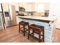 Stylish kitchen island with granite countertop, seating for two, and decorative tile accents at 126 Fleming Dr, Statesville, NC 28677