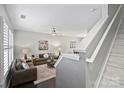 Bright living room featuring neutral walls, dark floors, plush seating, and staircase at 1909 Wilmore Walk Dr # 44, Charlotte, NC 28203