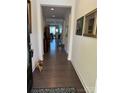 Inviting hallway with hardwood floors leading to dining area creates a seamless flow throughout the home at 129 Johnson Manor St, Mooresville, NC 28115