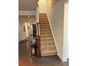 Staircase has carpeted steps, wooden banister, and landing table with decorative vases for added elegance at 129 Johnson Manor St, Mooresville, NC 28115