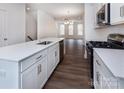 Modern kitchen with white cabinets, quartz countertops, and stainless steel appliances at 2208 Noble Townes Way, Charlotte, NC 28262