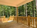 A clear view of the wooden porch and railing with lovely wooded scenery at 315 Bonaventure Dr, Salisbury, NC 28147