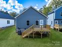 A backyard showcasing a private deck, complemented by a lush green lawn at 606 Meadow Ave, Spencer, NC 28159