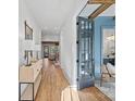 Light-filled entryway with hardwood floors, and a view into living room at 705 Mcalway Rd, Charlotte, NC 28211