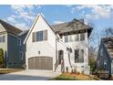 Two-story house with gray brick exterior, brown garage doors, and landscaping at 705 Mcalway Rd, Charlotte, NC 28211