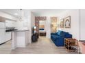 Bright living room with blue sofa, and view into bedroom and kitchen at 400 Queens Rd # E5, Charlotte, NC 28207
