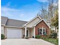 Front view of charming brick and siding home with landscaping at 191 Oak Village Pkwy, Mooresville, NC 28117