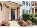 Front entrance of townhome with blue door and brick columns at 2030 Cambridge Beltway Dr, Charlotte, NC 28273