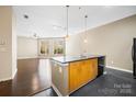 Open kitchen with dark countertops and stainless steel appliances, seamlessly flowing into the living area at 2125 Southend Dr # 349, Charlotte, NC 28203