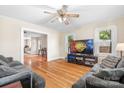 Open living room with hardwood floors, comfortable seating, and a large television at 2401 Boy Scout Rd, Lincolnton, NC 28092