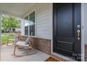 Inviting front porch featuring rocking chairs and a view of the well-manicured front yard at 3029 Quinebaug Rd, Fort Mill, SC 29715