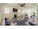 Bright living room with fireplace, hardwood floors, and ceiling fan at 119 Nat Barber Ave, Gastonia, NC 28052